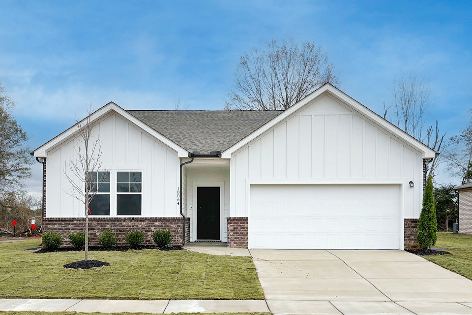A white house with a garage.