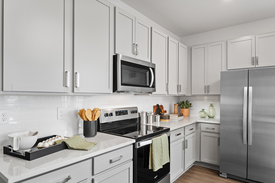 A kitchen with white cabinets.