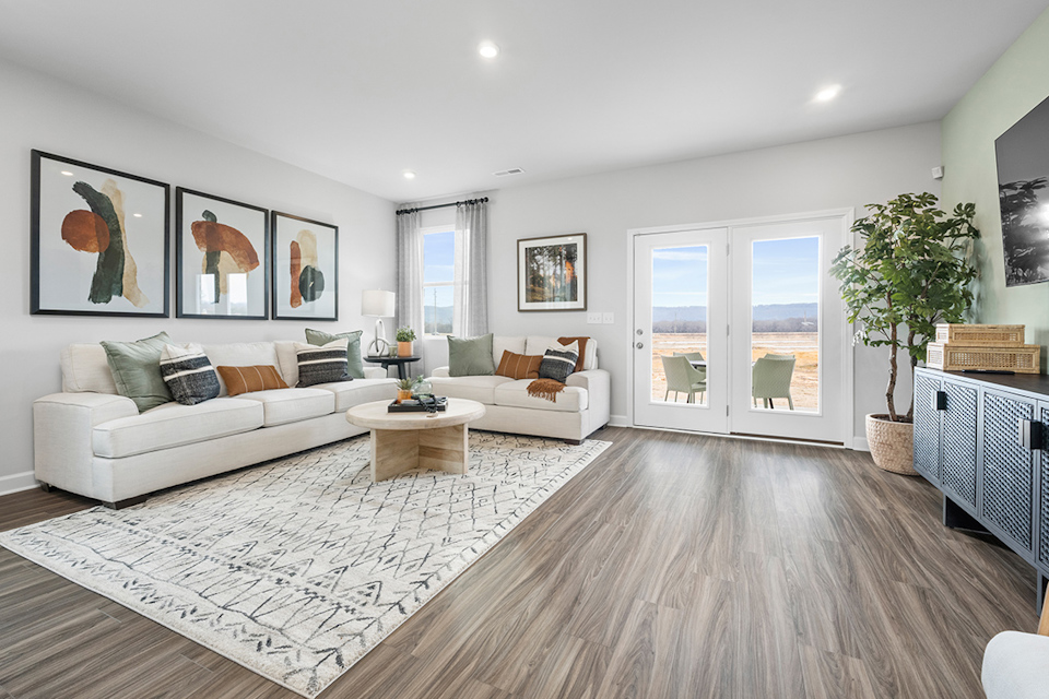 A living room with a rug and a fireplace.