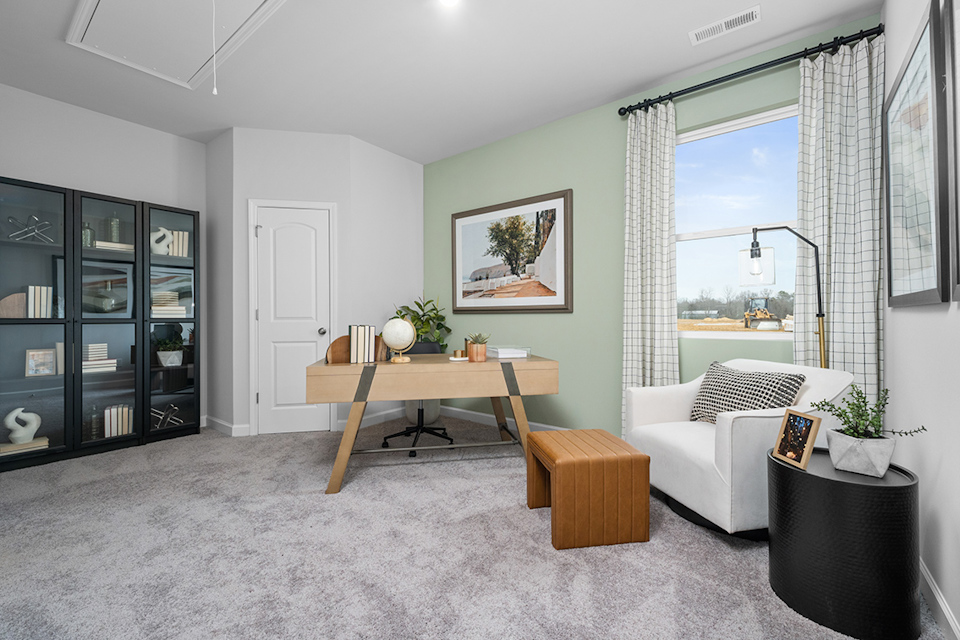 A living room with a table and chairs.