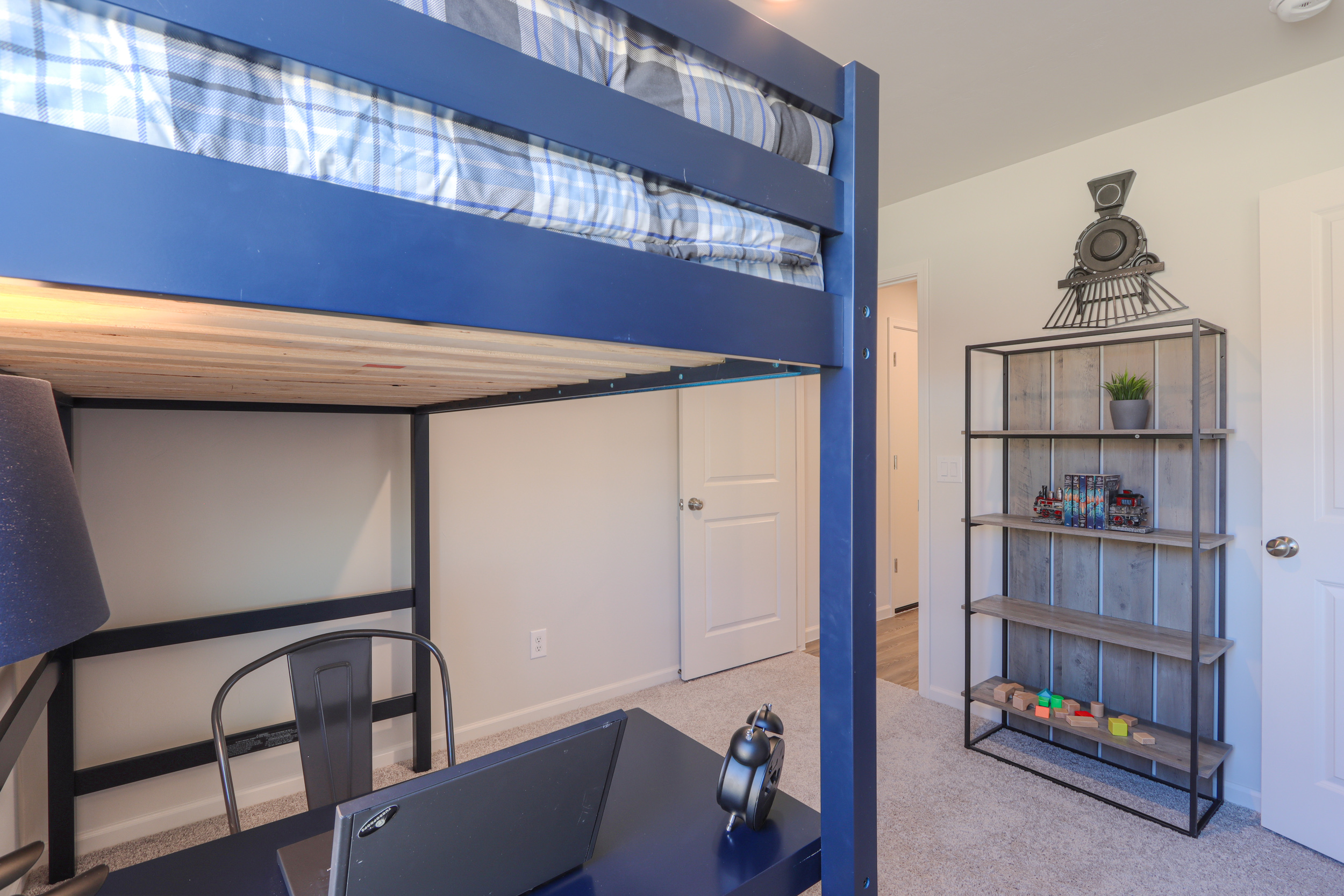 A room with a bed and shelves.