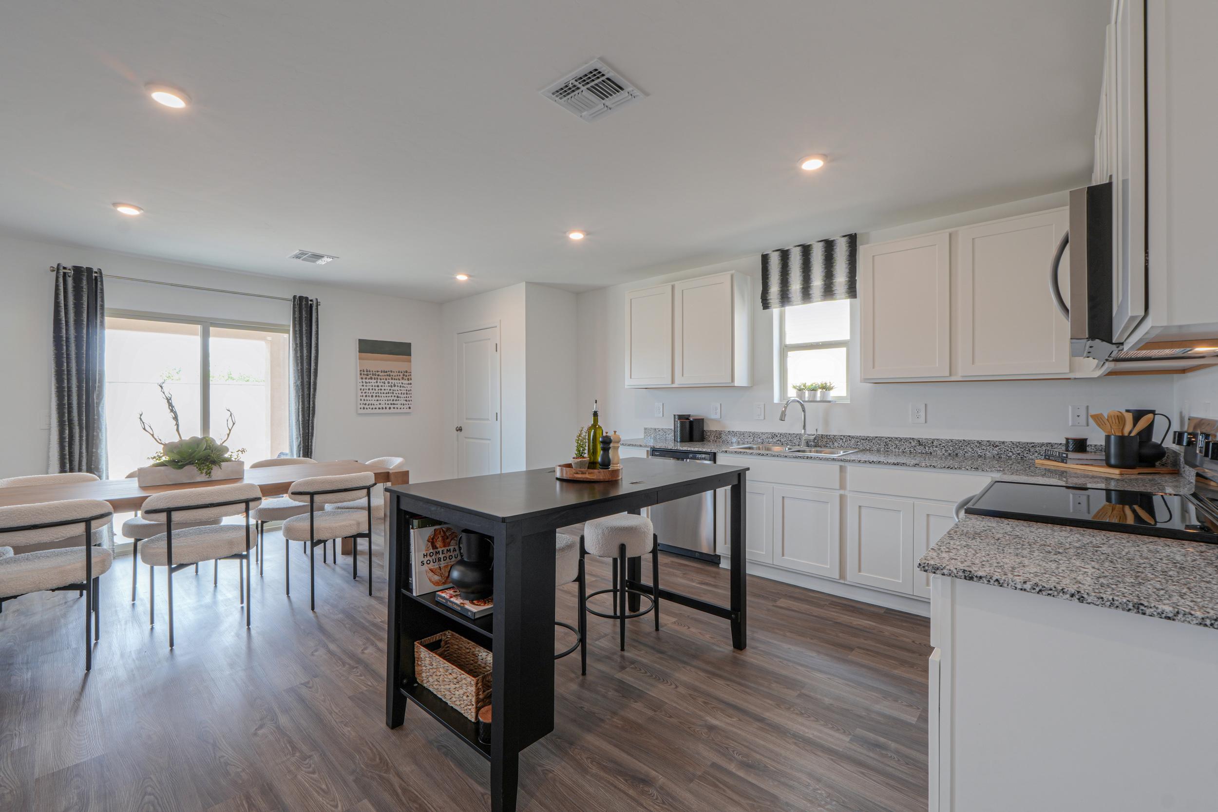 A kitchen with a wood floor.
