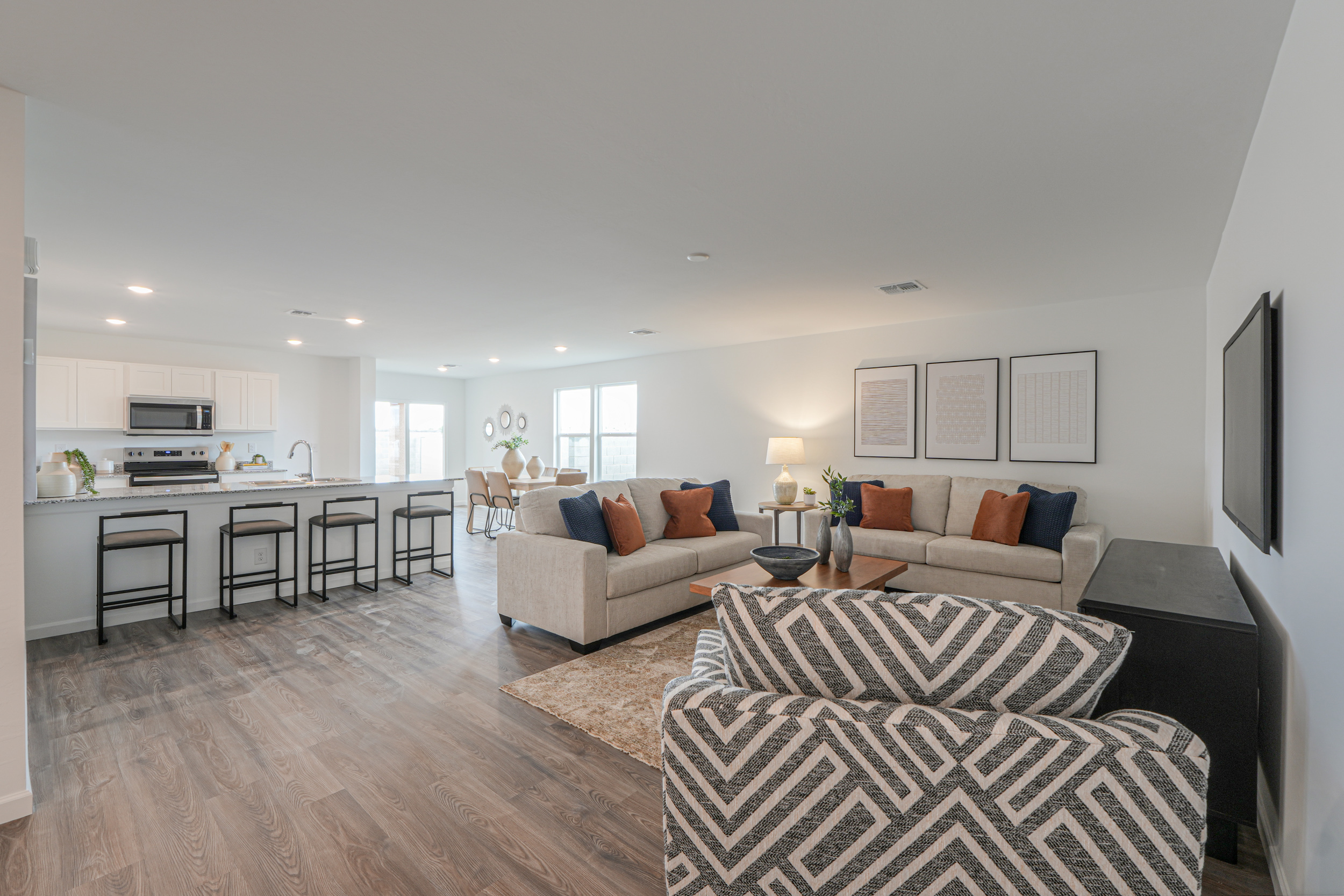 A living room with a large kitchen.
