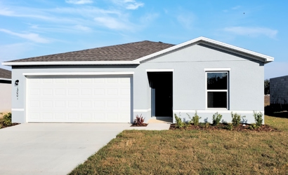 A white house with a garage.