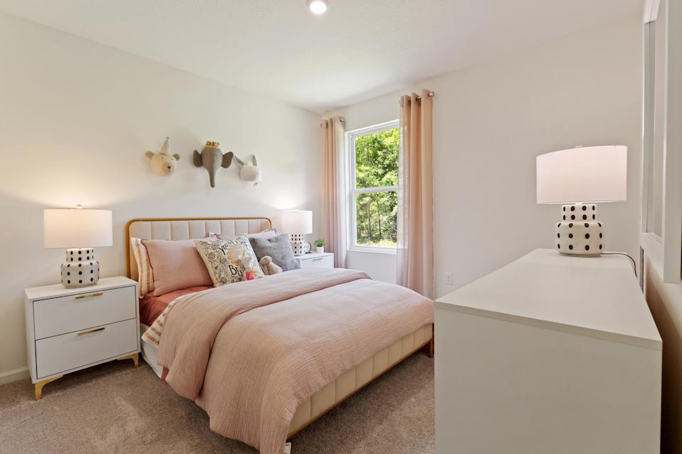 A bedroom with a bed and lamps.