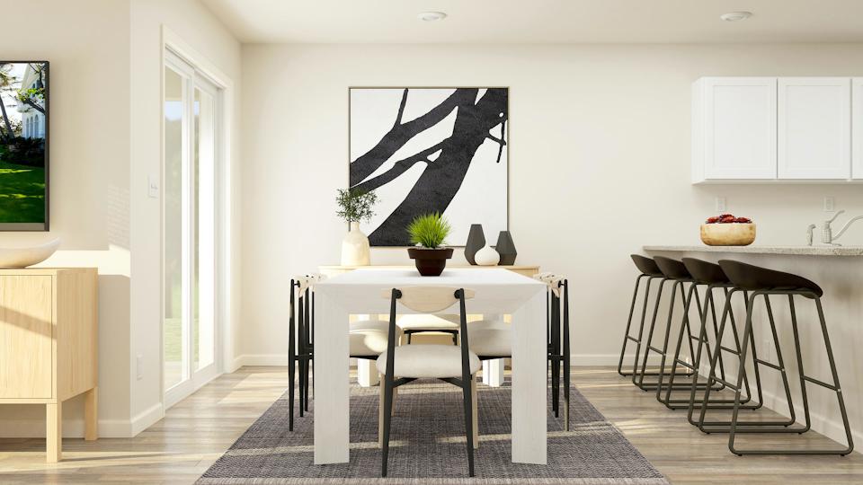 A dining room with a table and chairs.