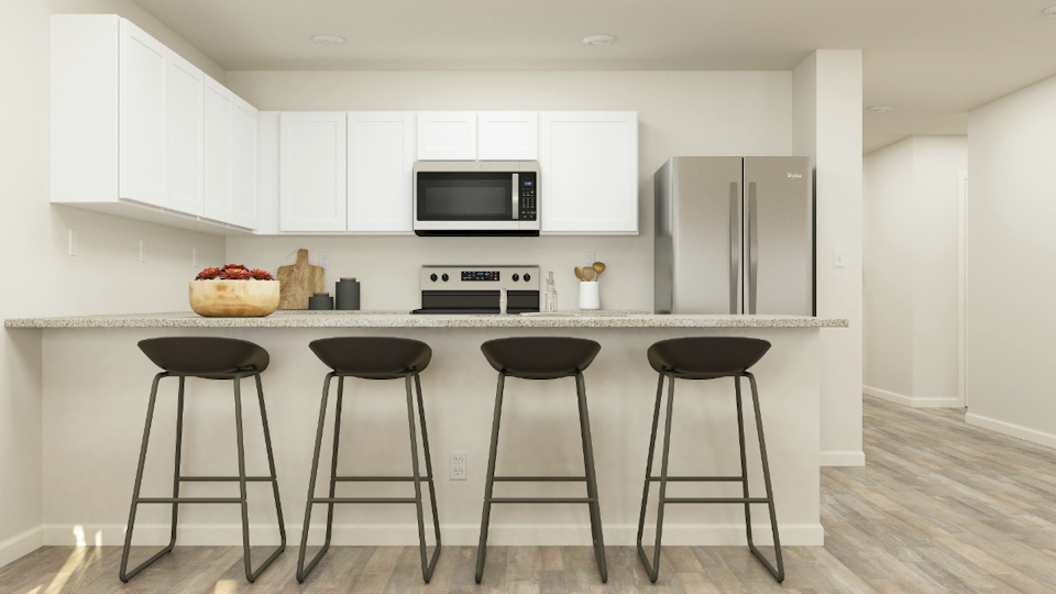 A kitchen with stools and a table.