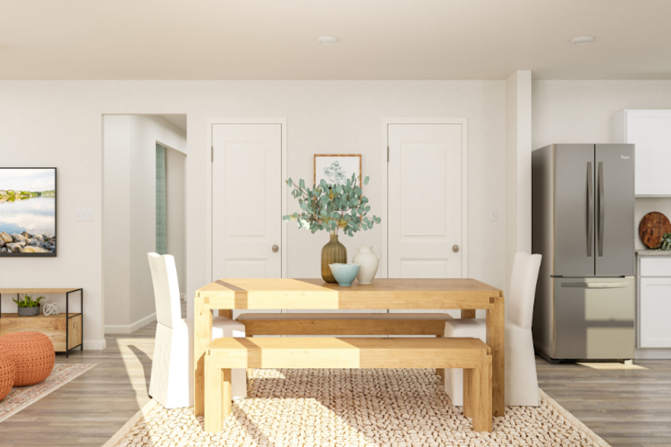 A living room with a table and chairs.