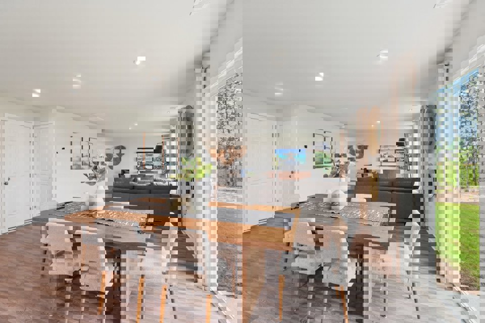 A living room with a large table and chairs.