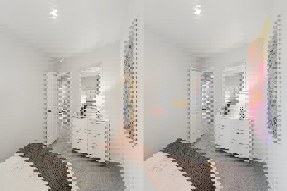 A bedroom with a bed and a lamp.