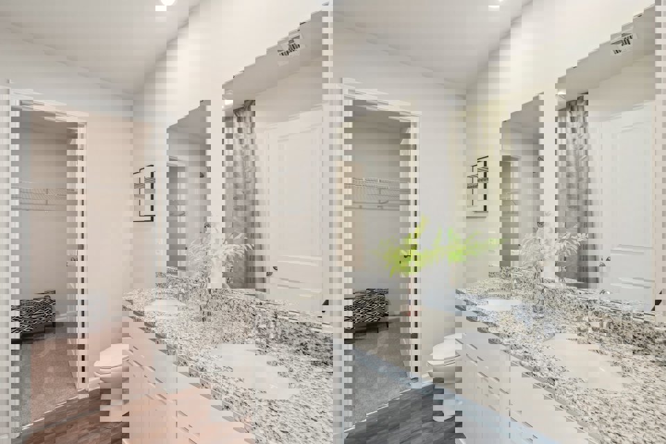 A bathroom with a large mirror.