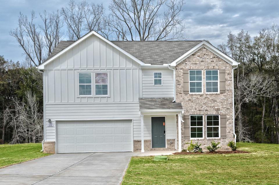 A grey house with a garage.
