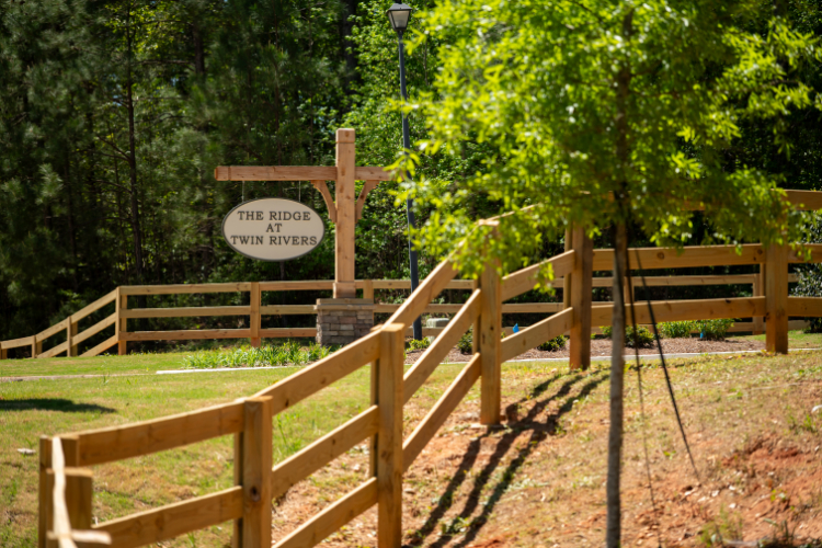 A wooden fence with a sign on it.