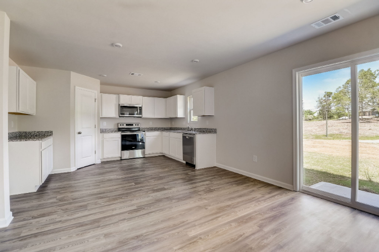 A kitchen with white cabinets.