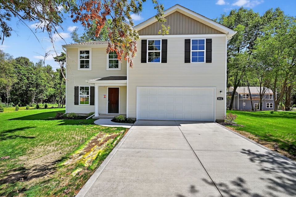A house with a garage with Ronald Reagan Boyhood Home in the background.
