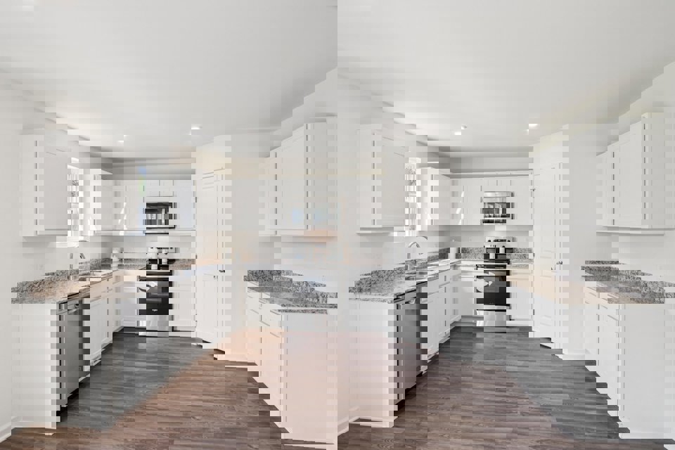 A kitchen with white cabinets.