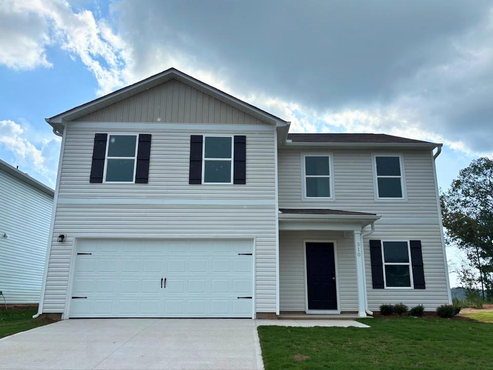 A white house with a garage.