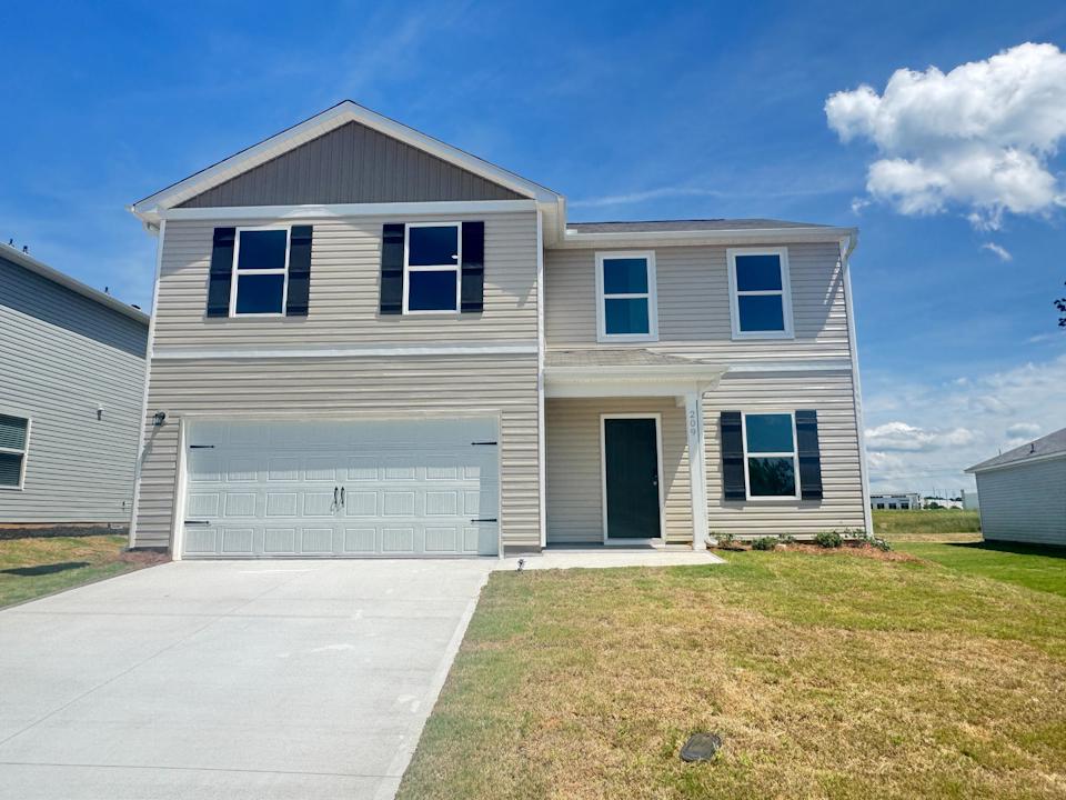 A white house with a garage.