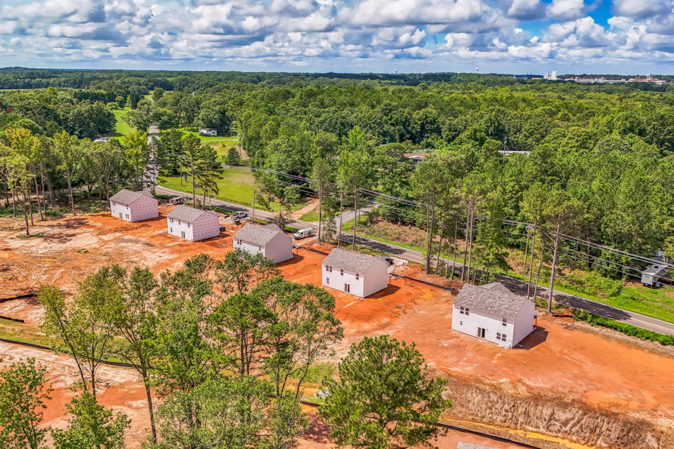 A group of buildings surrounded by trees.