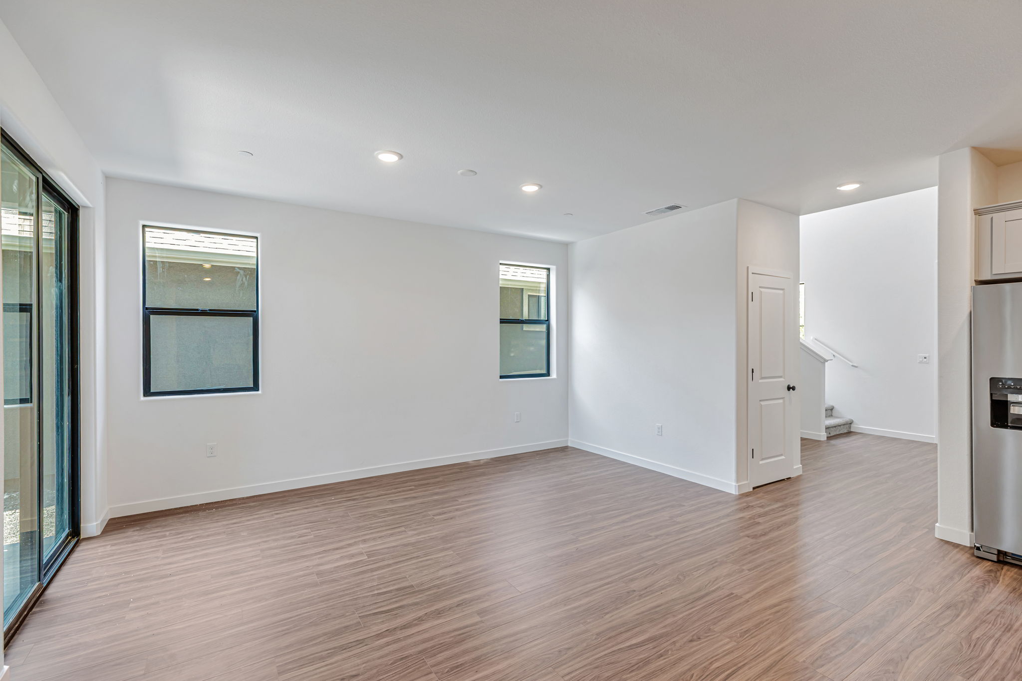 A room with white walls and wood floors.